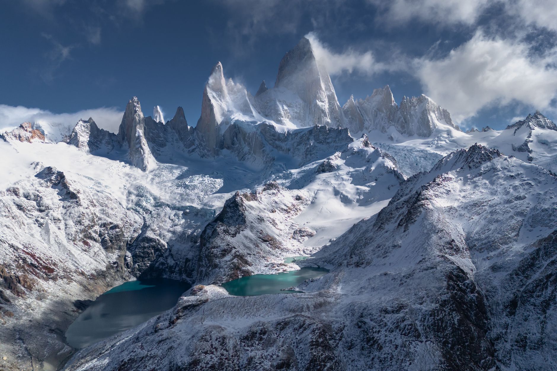 Dramatic snowy peaks and clear alpine lake