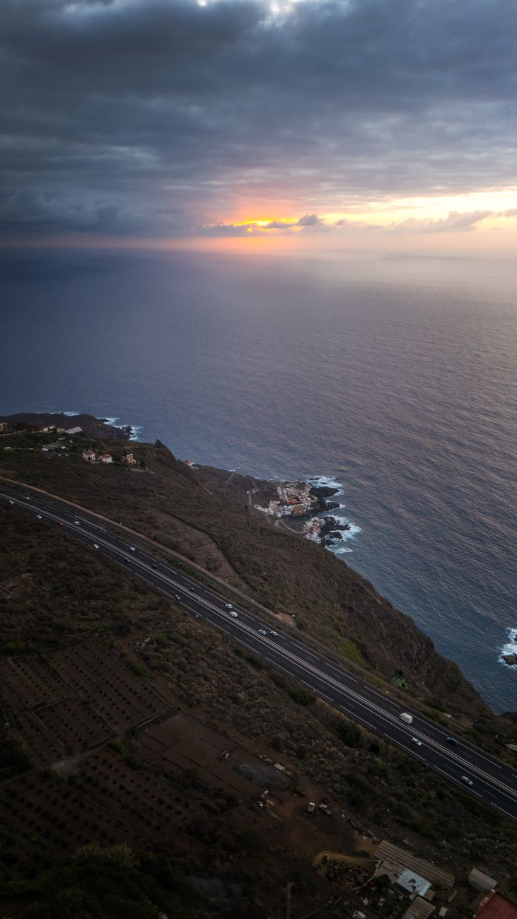 Atmospheric mountain pass and ocean cliff landscape