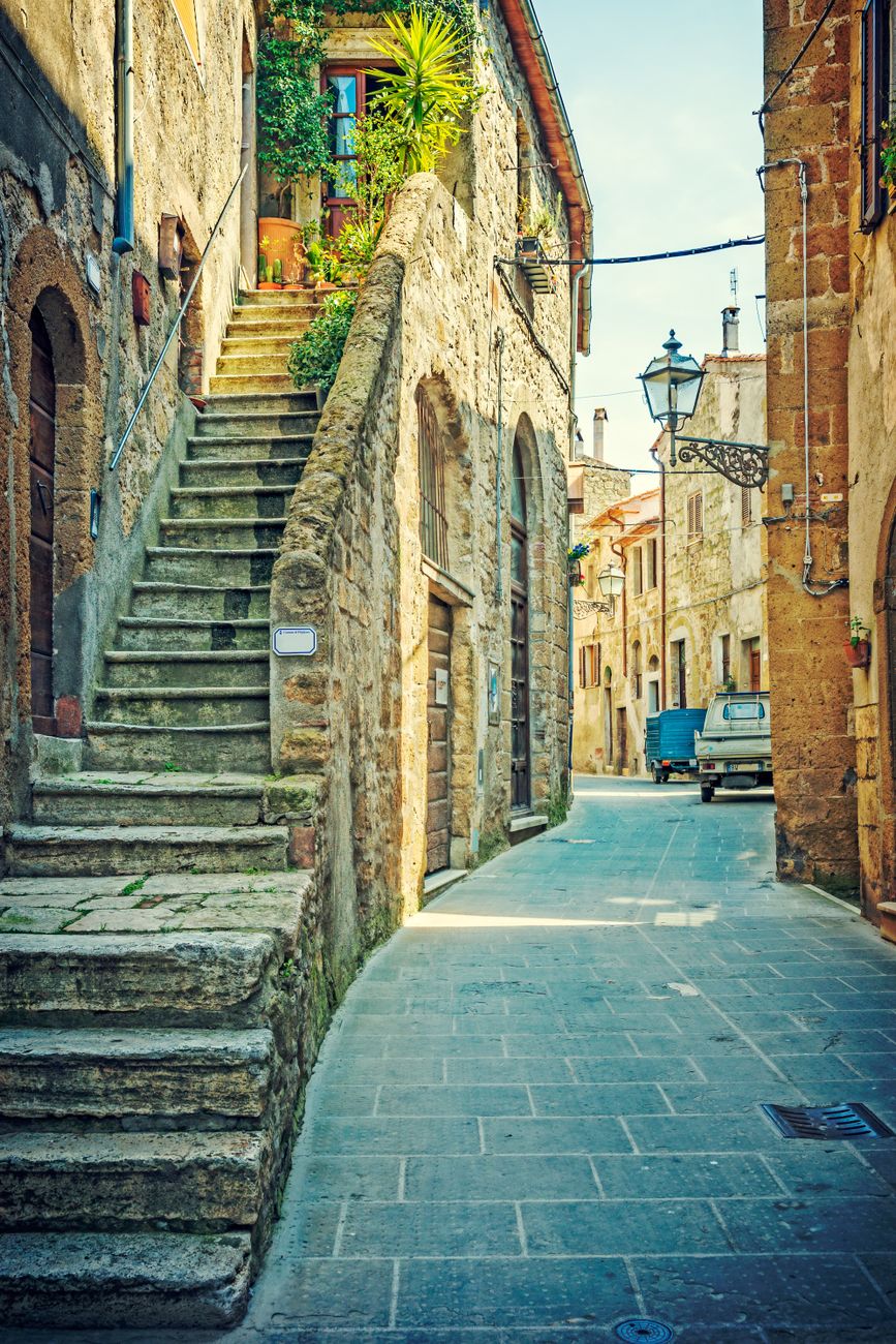 Historic architecture and sunlit cobblestone courtyard